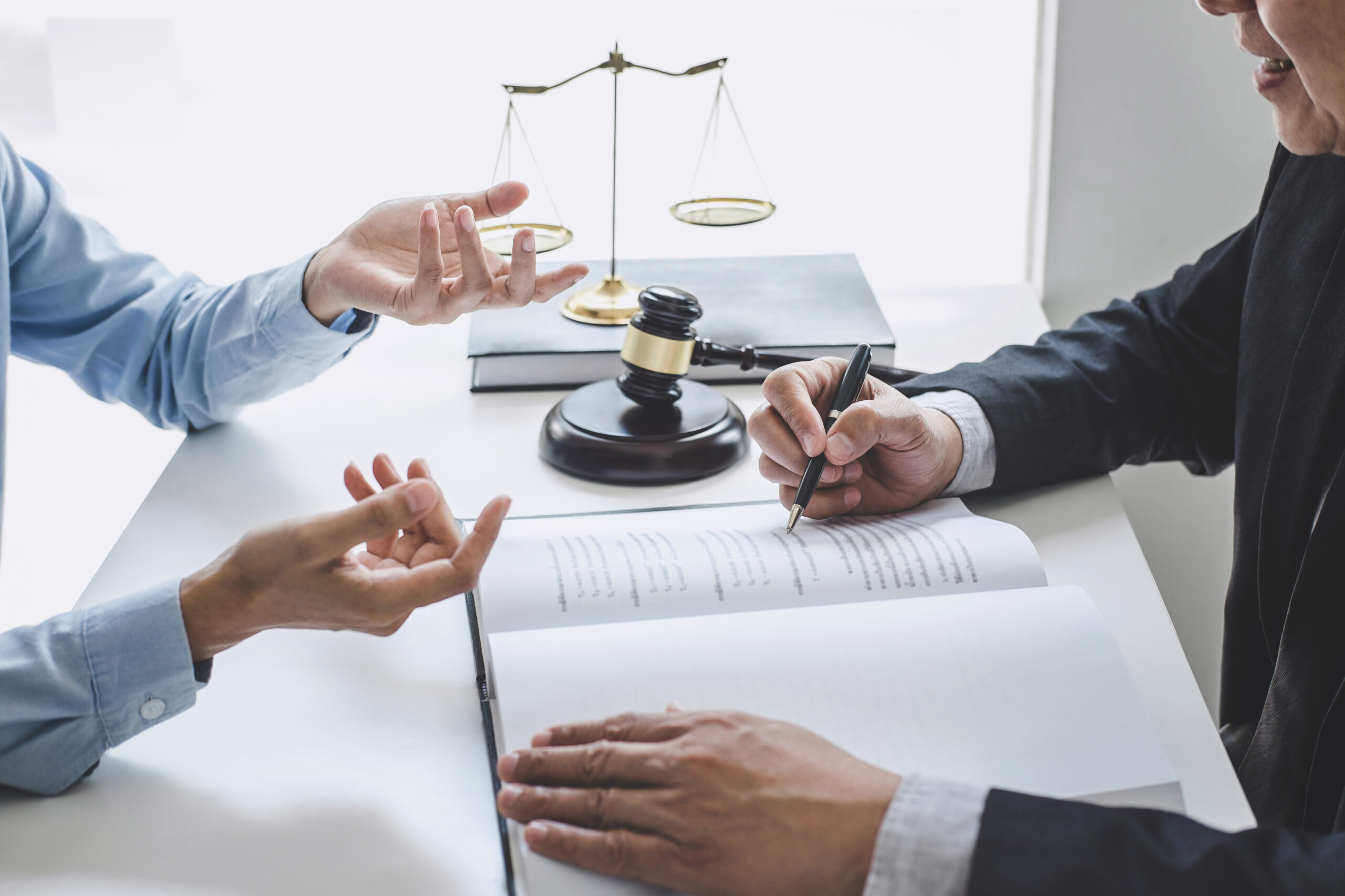 Client meeting with a Denver injury attorney to review a case file