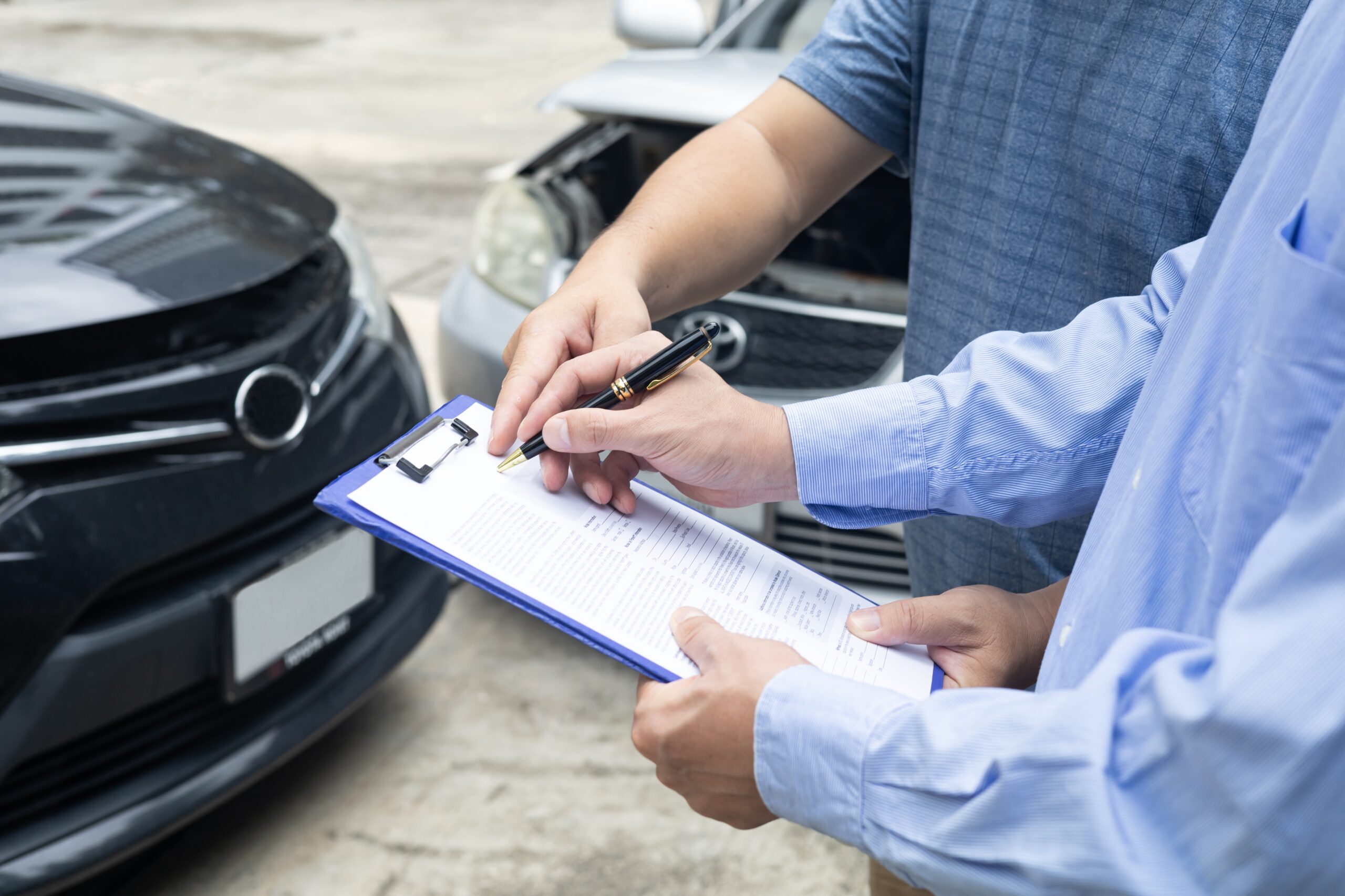 Insurance adjuster reviewing a vehicle collision claim file
