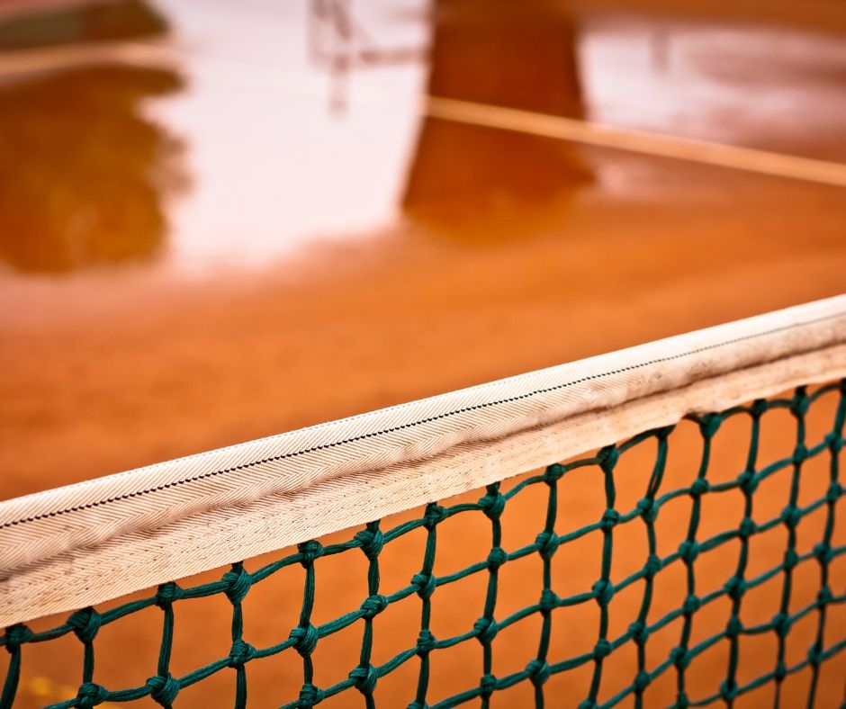 How does pressure washing help remove mold from tennis courts?