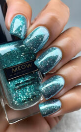 a hand holding a bottle of nail polish