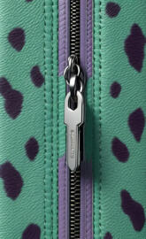 a silver and black guitar on a green carpet