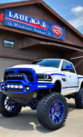 a blue truck parked outside a building